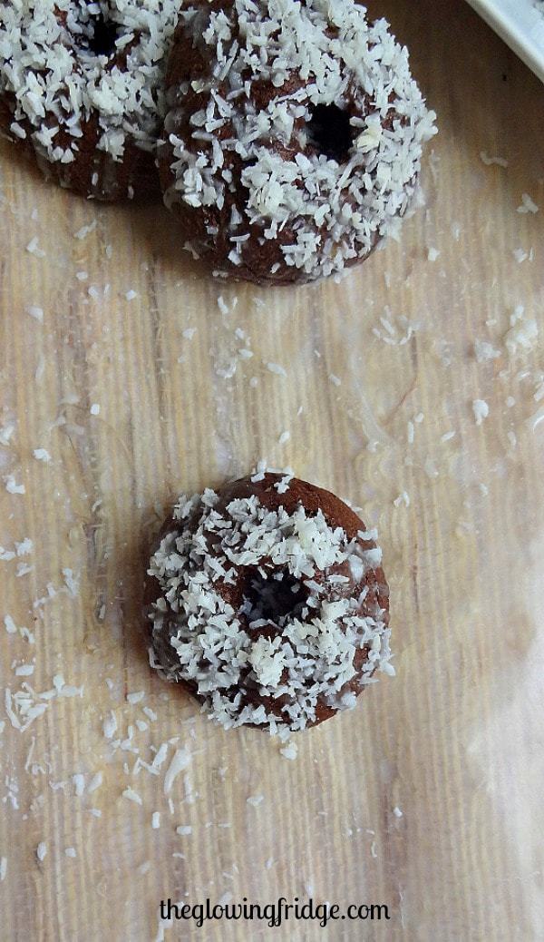 Fudgy Coconut Glazed Mini Donuts - vegan and no donut pan required! These bite-sized donuts are easy to make and fun to share. From The Glowing Fridge