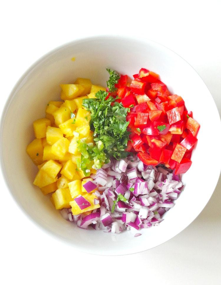 Raw Vegan Pineapple Salsa. FRESH, crunchy, spicy and sweet. This healthy salsa with a tropical twist is essential for summer. From The Glowing Fridge.