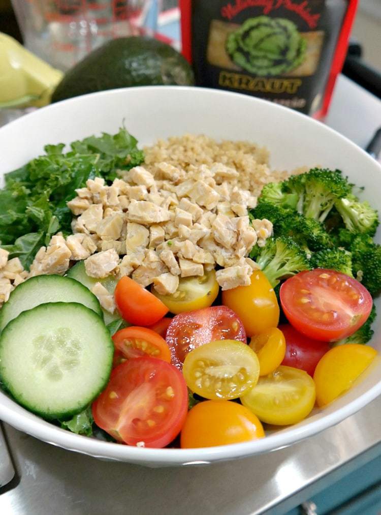 Hippie Macro Glow Bowl. Vegan and Gluten Free. A balancing blend of nourishing quinoa, leafy greens, saut?ed broccoli, crunchy cucumber and tomatoes and kraut with a creamy maple tahini dressing. The perfect combination for a feel-good meal! From The Glowing Fridge.