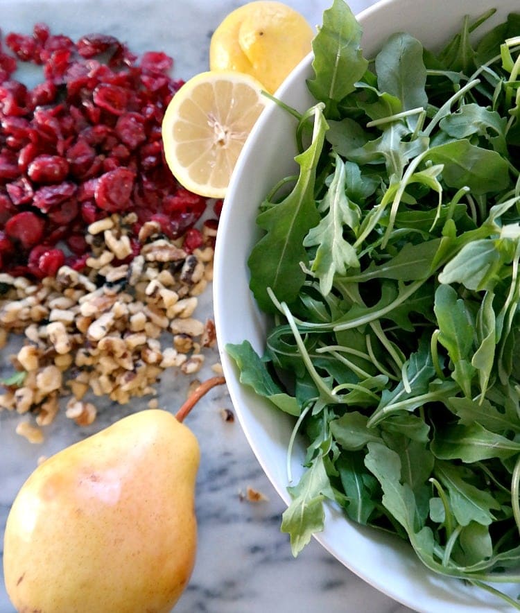 Arugula, Pear & Walnut Salad with a simple lemon dressing. Vegan + Gluten Free. Quick, balanced, seasonal, easy and so delicious! My new go-to everyday salad but perfect for holiday parties too. From The Glowing Fridge.