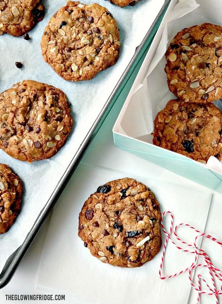 Cherry Chocolate Muesli Cookies - VEGAN - Bites of wholesome golden goodness with tart dried cherries, chocolate chips, date crumbles, chewy raisins and crunchy oats. Easy to bake and absolutely delicious! From The Glowing Fridge.