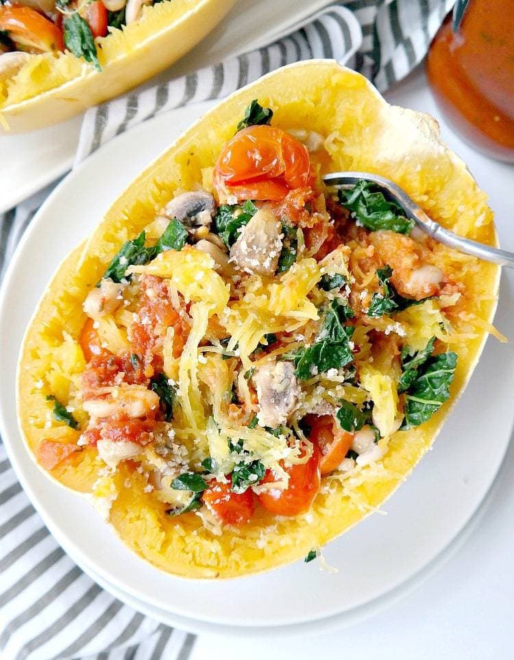 Tuscan Kale and White Bean Spaghetti Squash Bake - Vegan, Gluten Free & Low Fat. This healthy and hearty recipe is filling, nourishing and savory. With kale, tomatoes, mushrooms and white beans, it's a feel-good meal that's complete in the best way. From The Glowing Fridge.