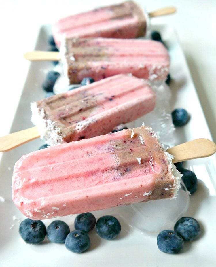 Summer Swirl Superfood Pops. Vegan popsicles made with coconut milk, superfoods like chia seeds and maca powder, plus antioxidant rich berries. Healthy, sweet & a super simple frozen treat! From The Glowing Fridge. #vegan #popsicles #summer #treat