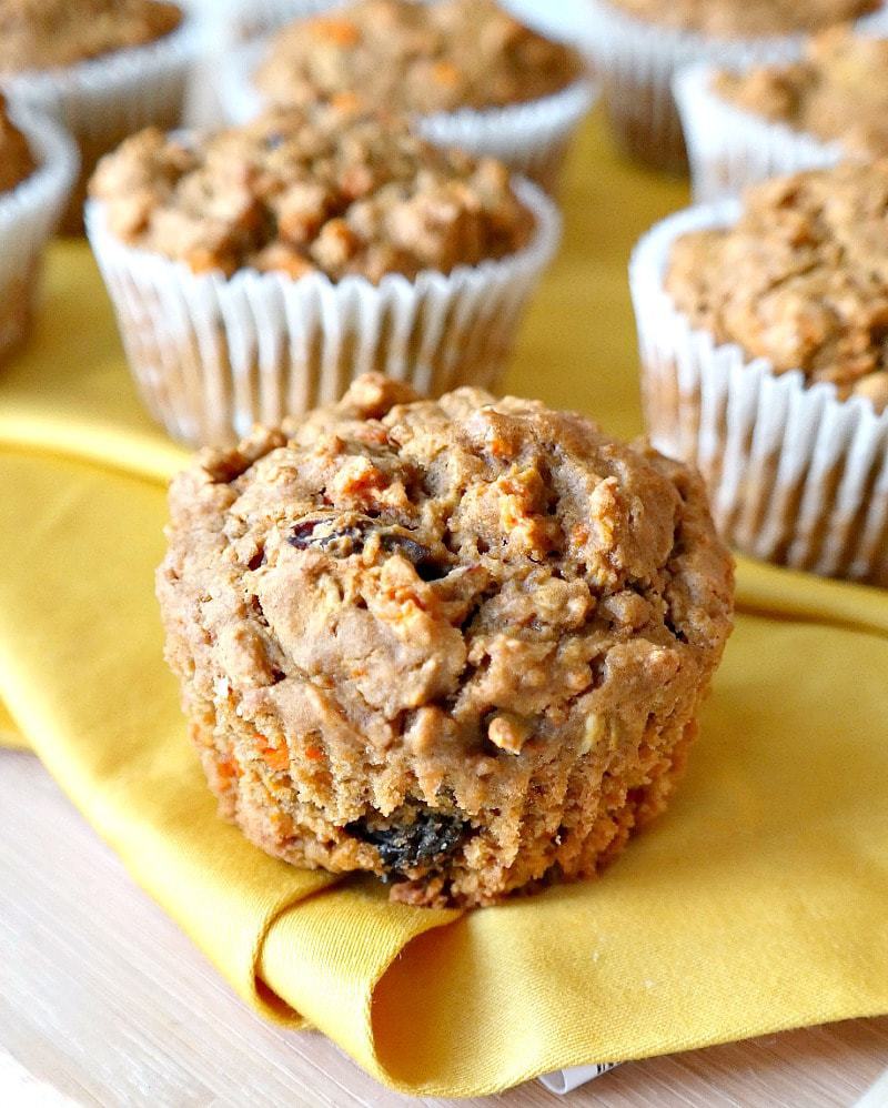 Carrot Cake Muffins with Maple Orange Cashew Frosting. Vegan & Gluten-Free. Fluffy and moist - made with oat flour, warming spices, grated carrot, raisins and applesauce for a wholesome on-the-go snack or quick breakfast. Slather with creamy orange-infused maple cashew frosting and turn it into a treat! #carrot #cake #muffins #vegan
