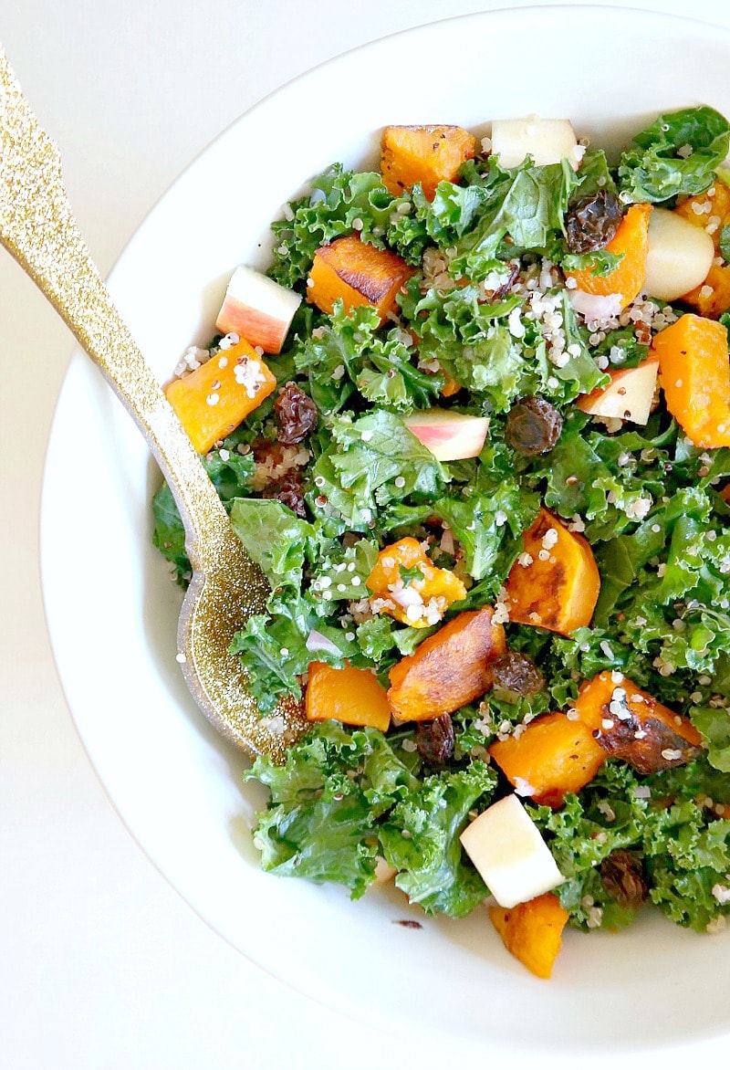 Harvest Kale and Quinoa Butternut Squash Salad. Vegan and Gluten Free with a Oil-Free Champagne Vinaigrette. Roasted butternut squash, crisp apple, nourishing quinoa, kale and raisins for a hint of sweetness. A lean, clean & green fall recipe that's perfect for Thanksgiving or any holiday party. #vegan #fall #autumn #salad