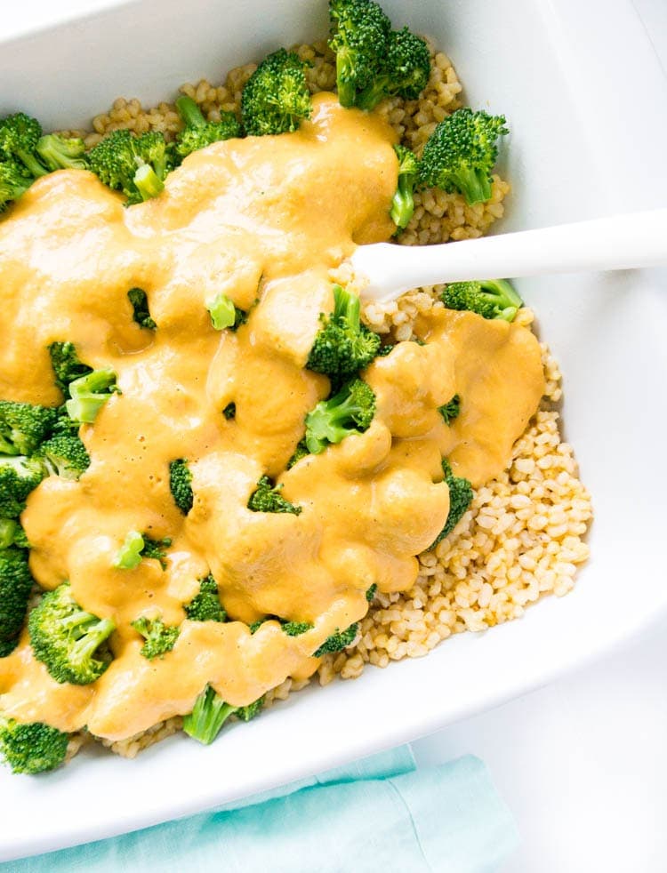 Cheesy Vegan Broccoli Brown Rice Bake. Oil Free, Gluten Free, Nut Free, Dairy Free. This is plant based cold-weather comfort food, with literally the BEST savory cheese sauce, that's also high in plant protein. #vegan #cheesy #casserole
