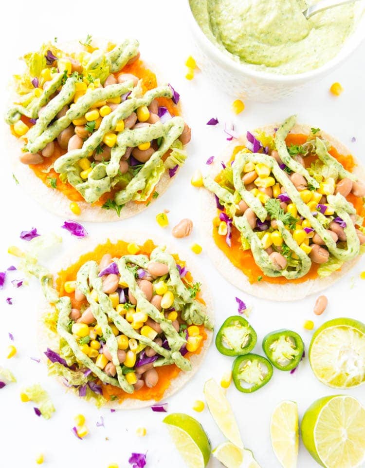 Roasted Sweet Potato Mash Tostadas. Vegan, Oil Free, Gluten Free. Clean, super simple and lots of fun to make! With a pinto bean & sweet corn mixture, all the toppings and a Spicy Magic Green Sauce. Healthy, satisfying and vibrant! #vegan #tostadas