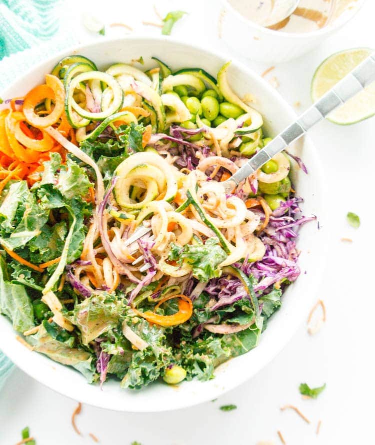 Vegan, Gluten Free. Crunchy Thai Noodle Salad and Oil-Free Spicy Almond Butter Dressing. With kale, raw carrot noodles, zoodles, cabbage, edamame and optional brown rice noodles, with the most decadently creamy dressing! 