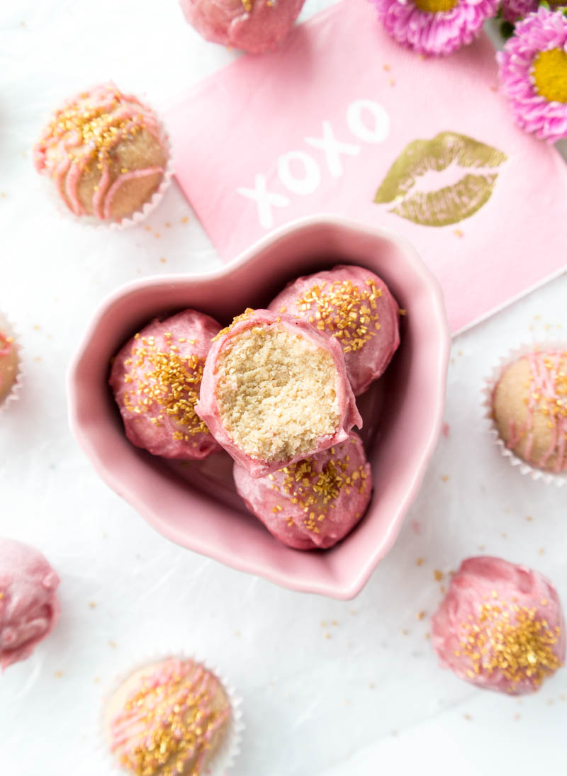 Glazed No-Bake Bliss Bites. Vegan, Gluten Free, Paleo, Nut-Free Version. Healthy, vanilla cake protein balls with Coconut Oil Glaze, using natural food coloring for a blush pink color. Perfect for special occasions, and so easy to make! #vegan #valentinesday #treats