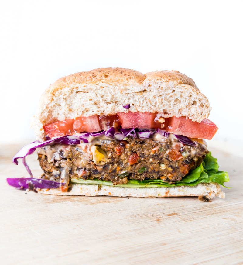 Vegan & Gluten Free 'Spicy Black Bean Burgers'. Thick & firm, they actually hold together. No crumbling! Scrumptiously tasty, easy & healthy black bean veggie burgers. Reliable for summer cookouts and parties, to impress even the most skeptical of guests. #vegan #blackbean #burger