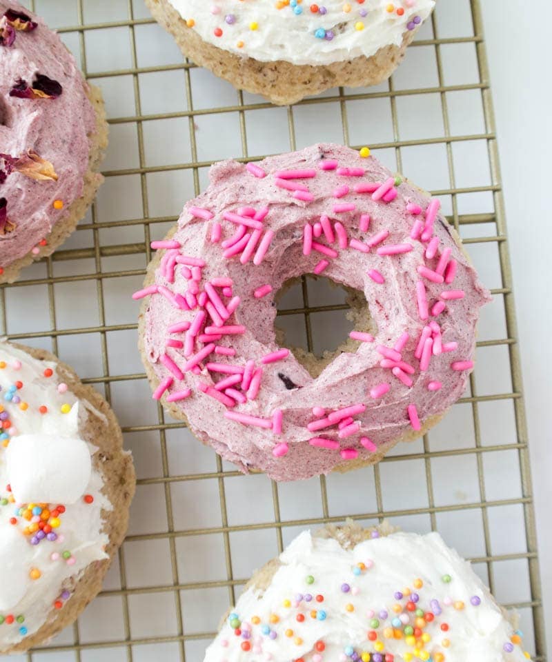 Baked Vegan Cake Donuts. Fluffy, only 9 simple ingredients with a glaze or frosting option! These yummy donuts come together quickly and are easy enough that anyone can make them! #vegan #donuts #frosted #baked #cake