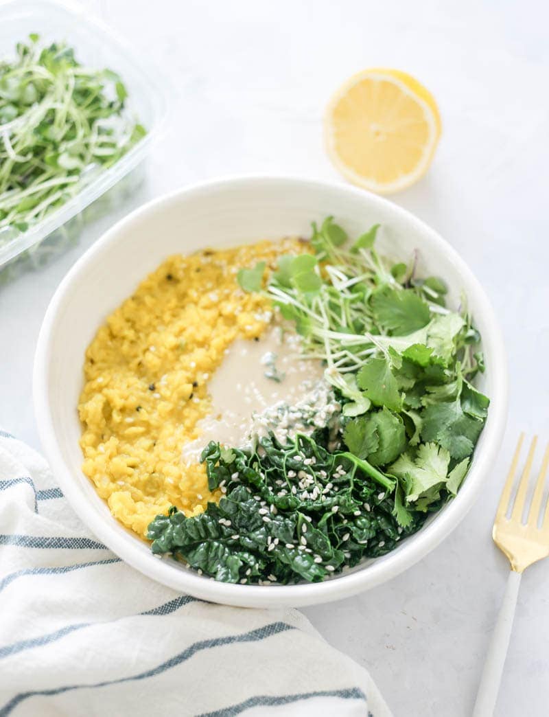 Healing Ayurvedic Kitchari Glow Bowl. A balancing, savory, cleansing and nourishing plant based vegan recipe that is super simple and delicious! Made with a blend of healing spices. #kitchari #healingrecipe