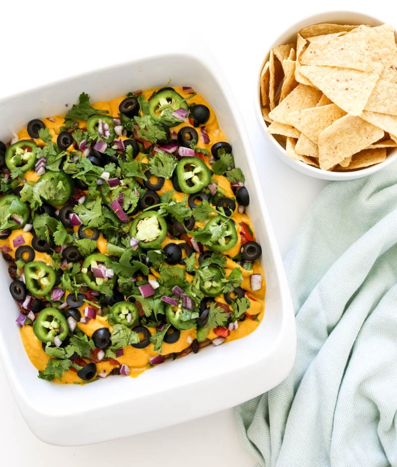 Vegan Mexican Seven-Layer Dip. It's FRESH, creamy and classically delicious, all in one crowd-pleasing bite. It makes for the best snacking, with corn tortilla chips of course. #vegan #mexican #layer #dip #appetizer