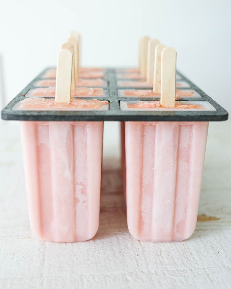 Watermelon Peach Popsicles. Dairy-free and vegan. Made with hydrating watermelon, juicy peaches and coconut cream for a dreamy summer popsicle! #vegan #popsicles #watermelon #peach #coconut